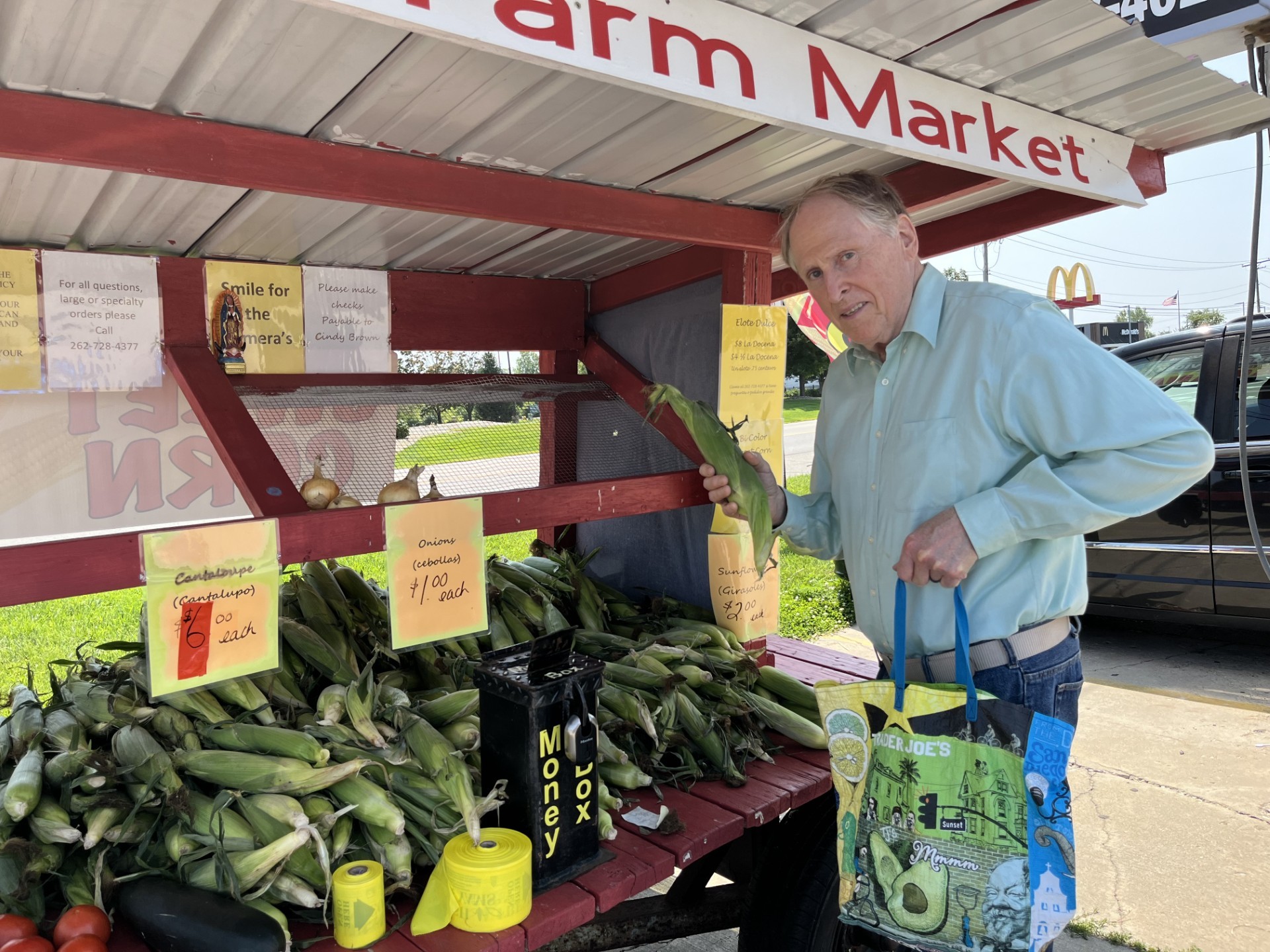 Scott Summers at a local farmstand purchasing corn