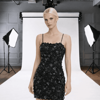 3D illustration of cream and gray overlapping chat bubbles with three dots inside, symbolizing communication, set against a black background.