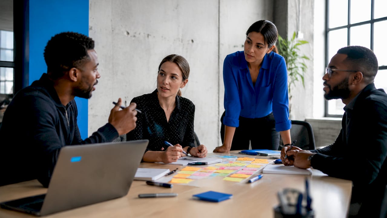 Diverse agile team collaborating around table