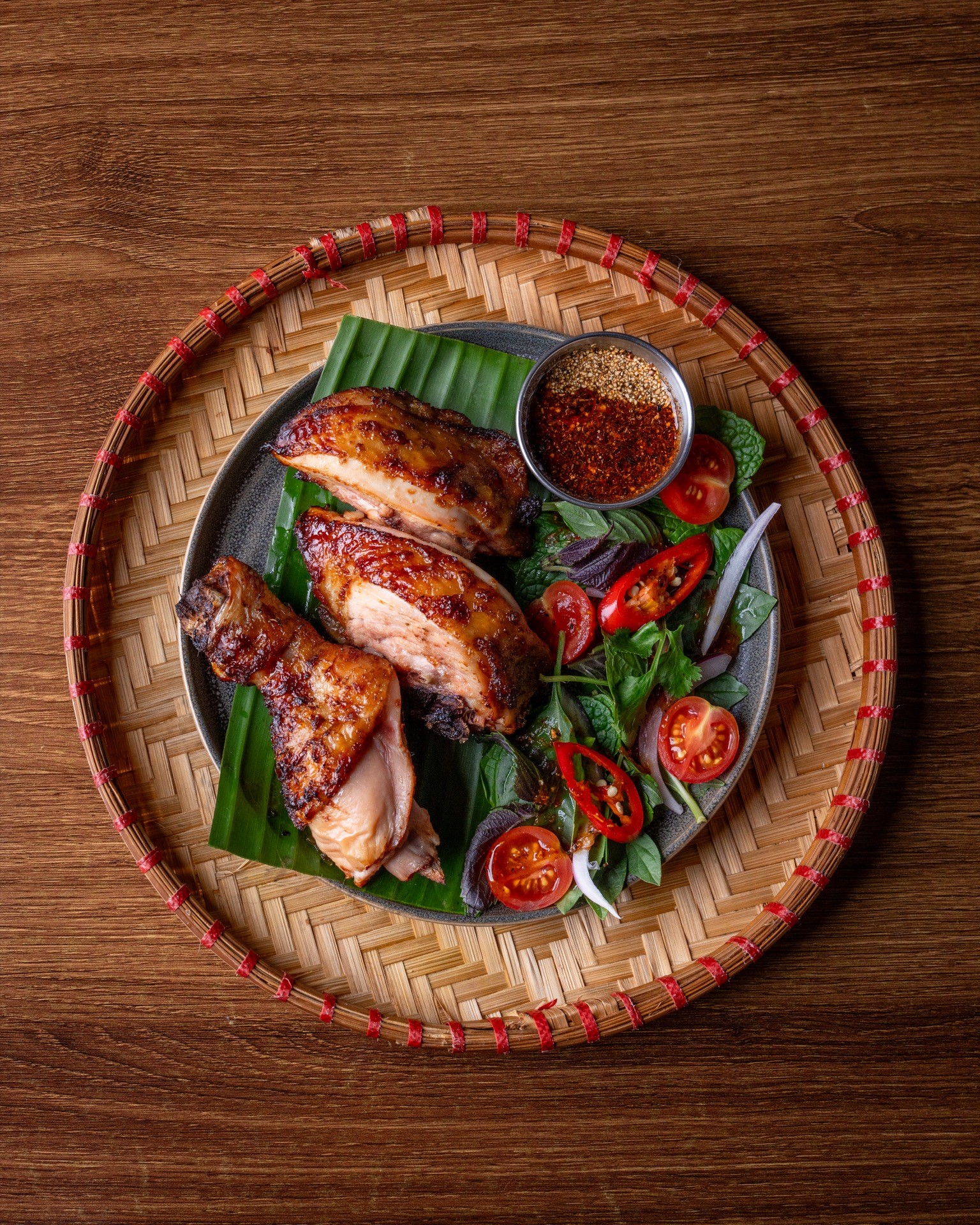 Grilled chicken platter on a woven tray
