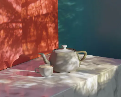 A decorative table setting featuring a silver teapot and cups on a colorful patterned tablecloth.