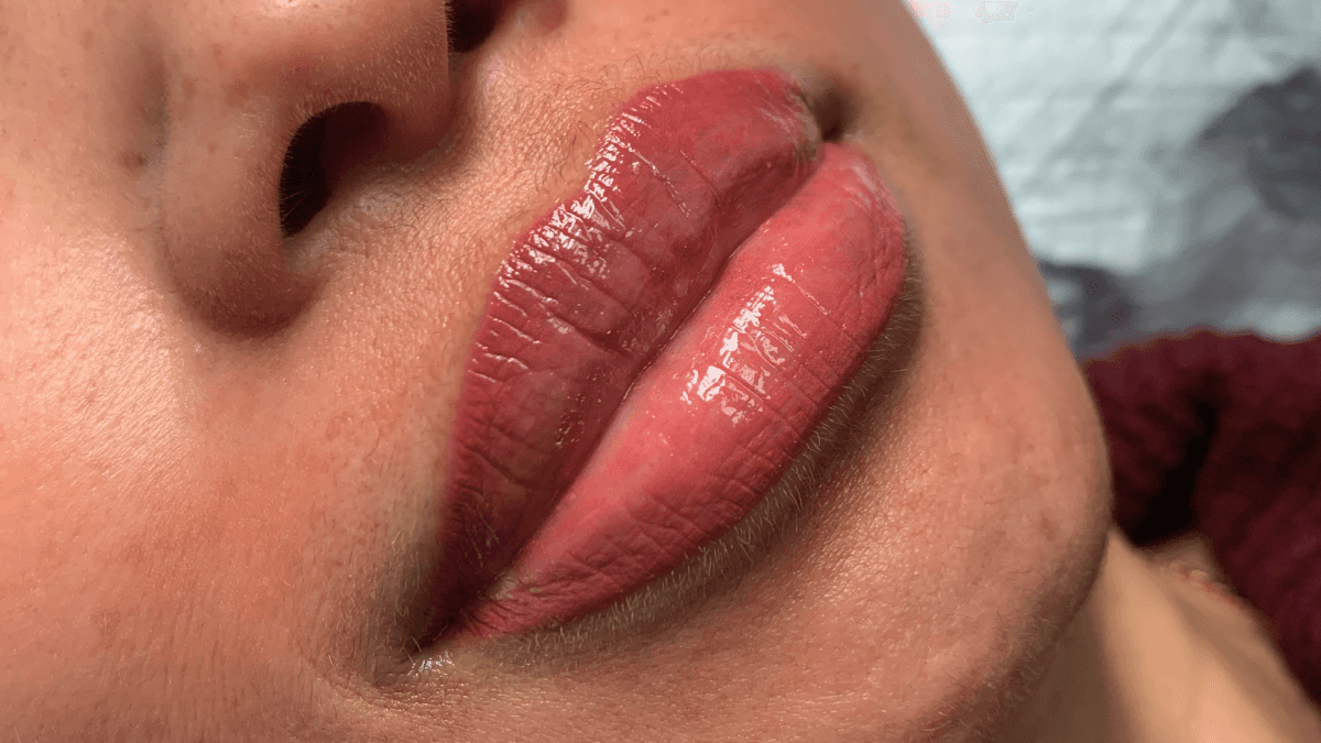 Close-up of lips after a lip blushing procedure, showing soft, natural pink color and enhanced definition.