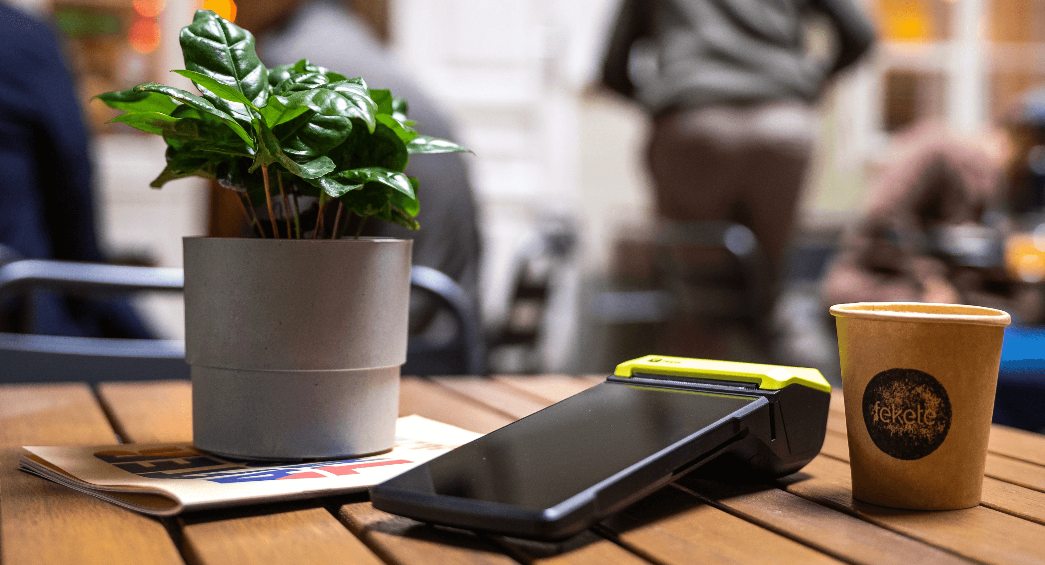 Teya card machine on a table with coffee