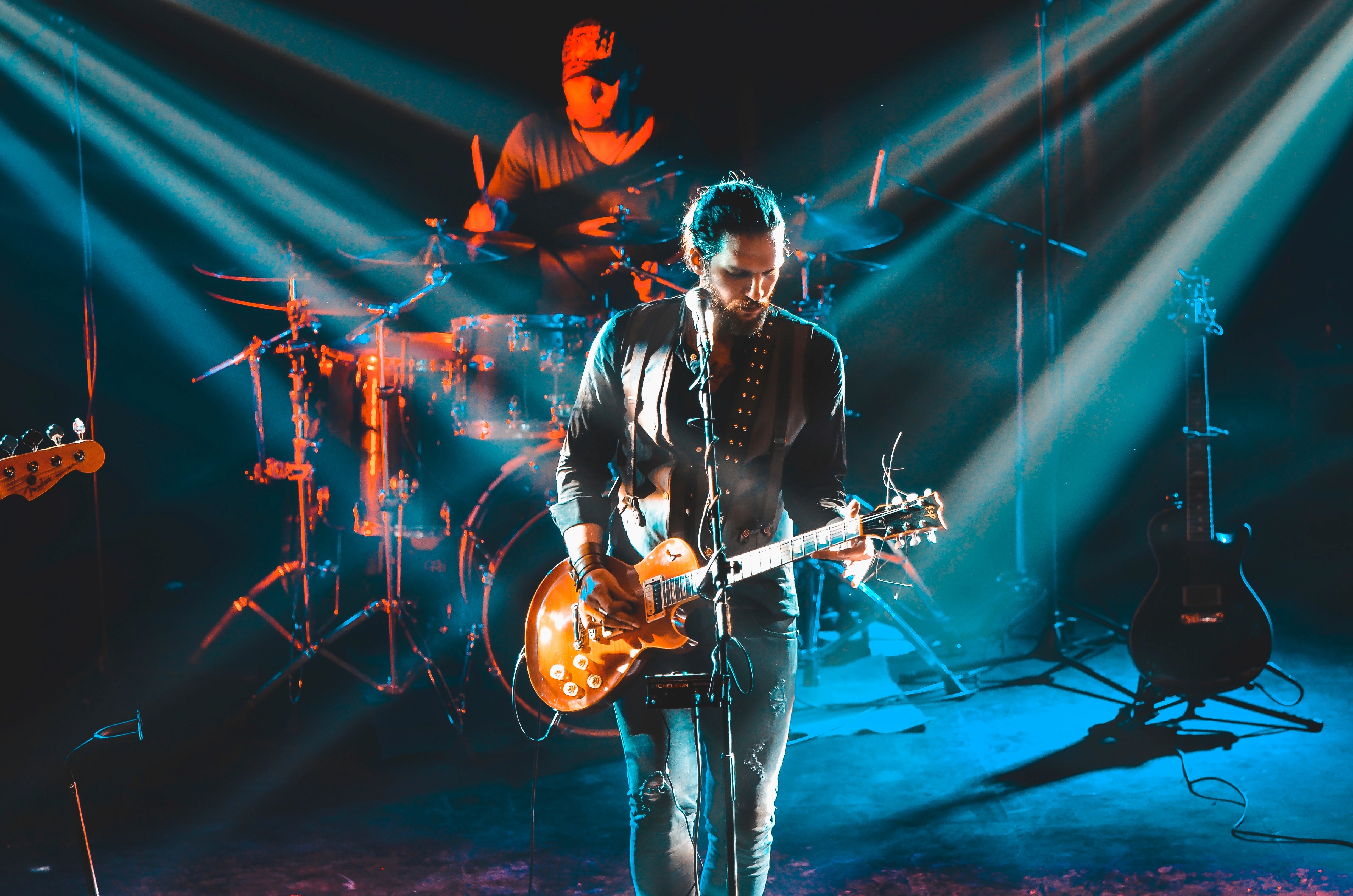 Songer in a concert playing guitar - ai artist singing other songs