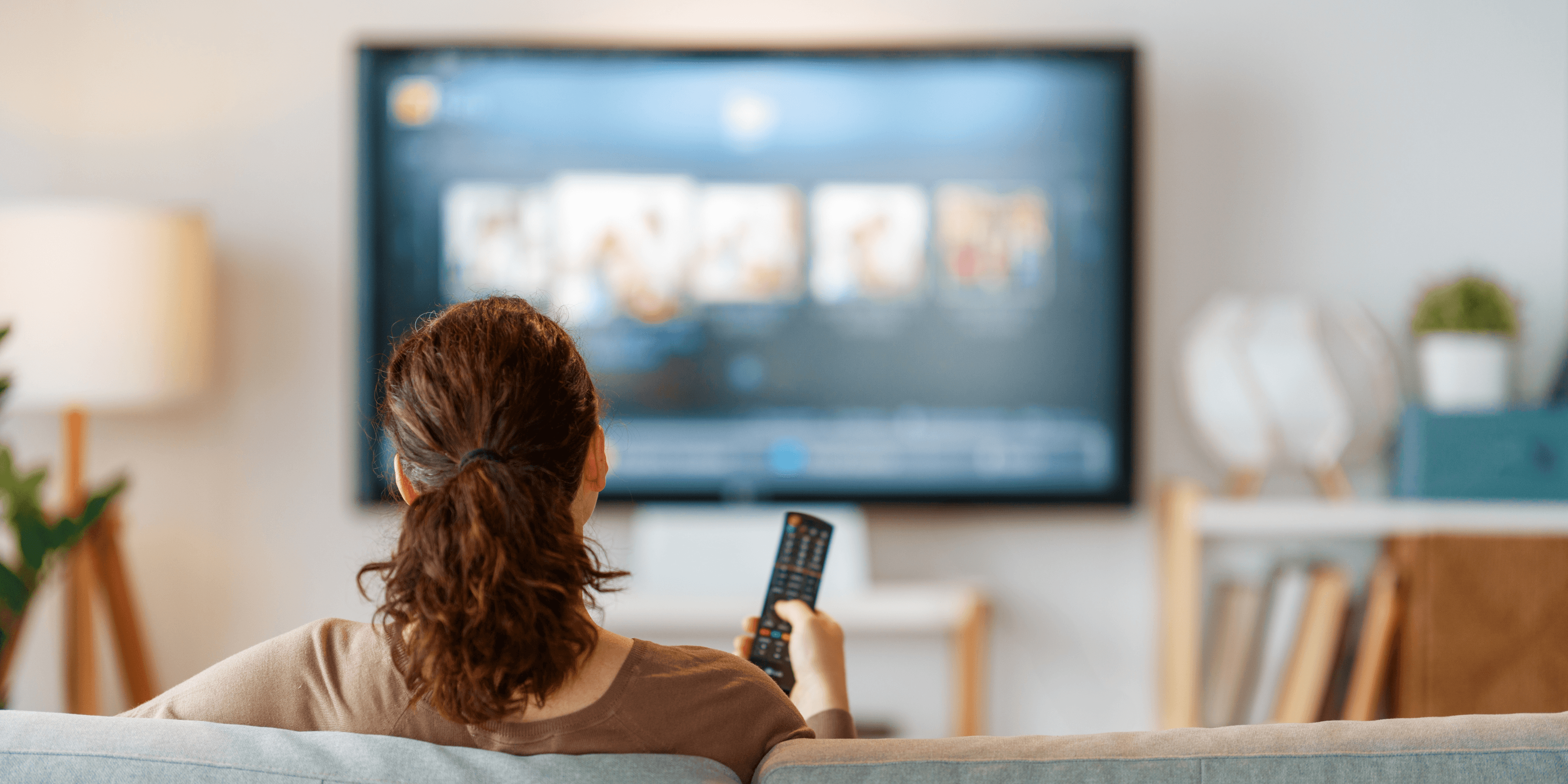 woman holding a phone and man looking at the phone. both are smiling