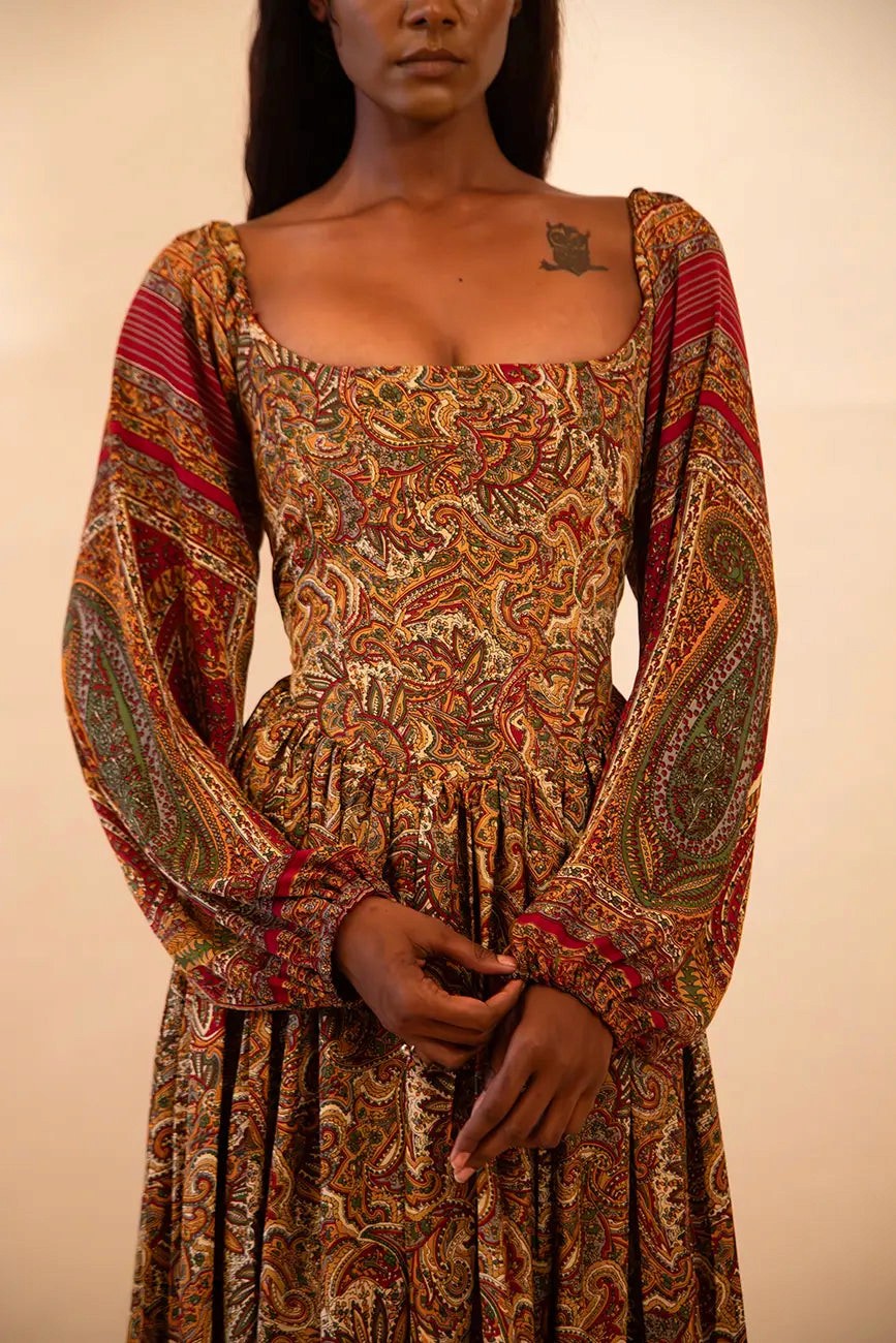 IRA our one of a kind, brown printed maxi dress. the garment comprises of puff sleeve and a back tie 