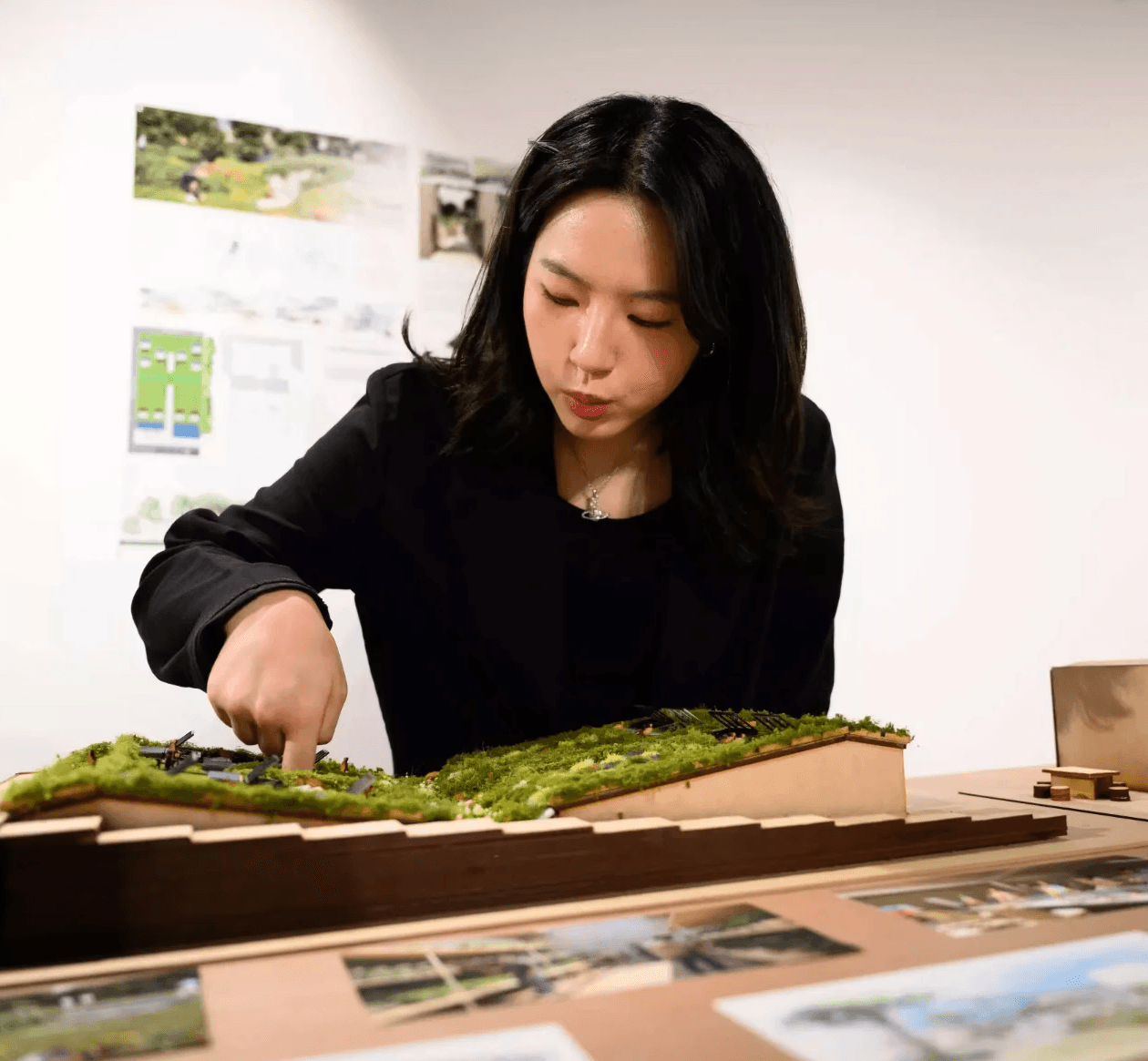 Jisu Han working with The Nest architectural model