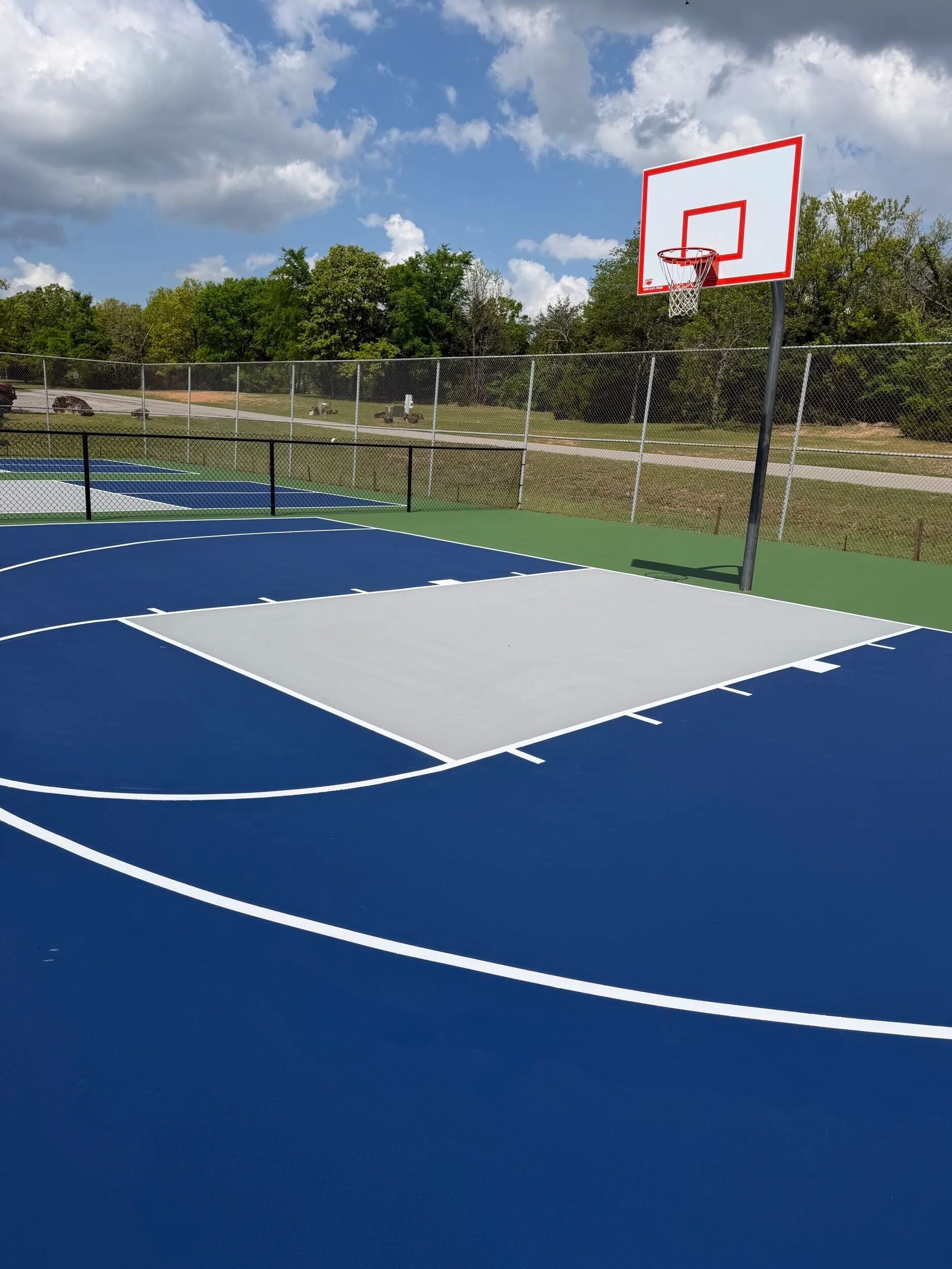 Close-up of resurfaced basketball court key and hoop at Bell Park in Greenwood, AR