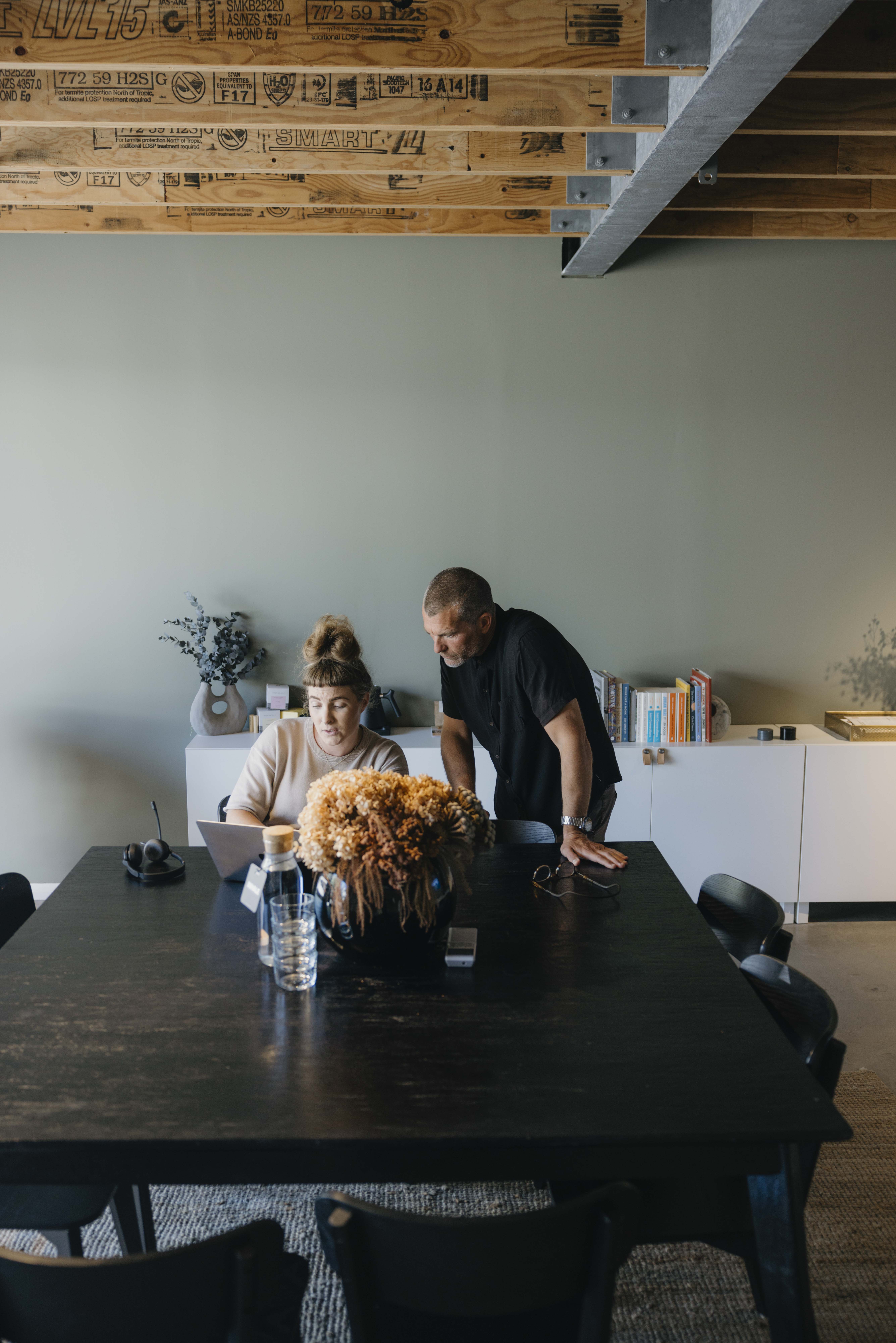Modern kitchen and dining area with large windows.