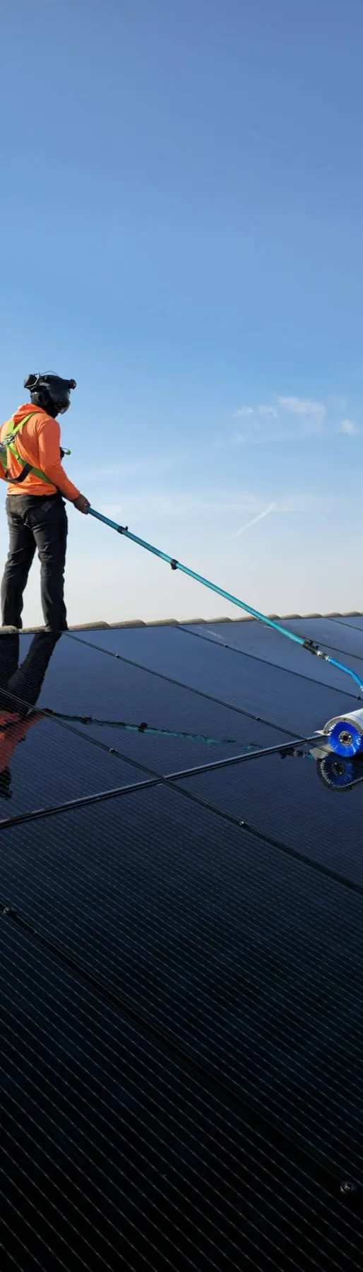 Technician cleaning rooftop solar panels | Premier Solar Service, serving Fresno, CA
