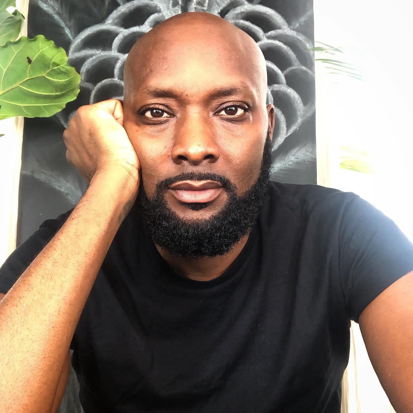 A smiling happy customer with curly hair on a blue background