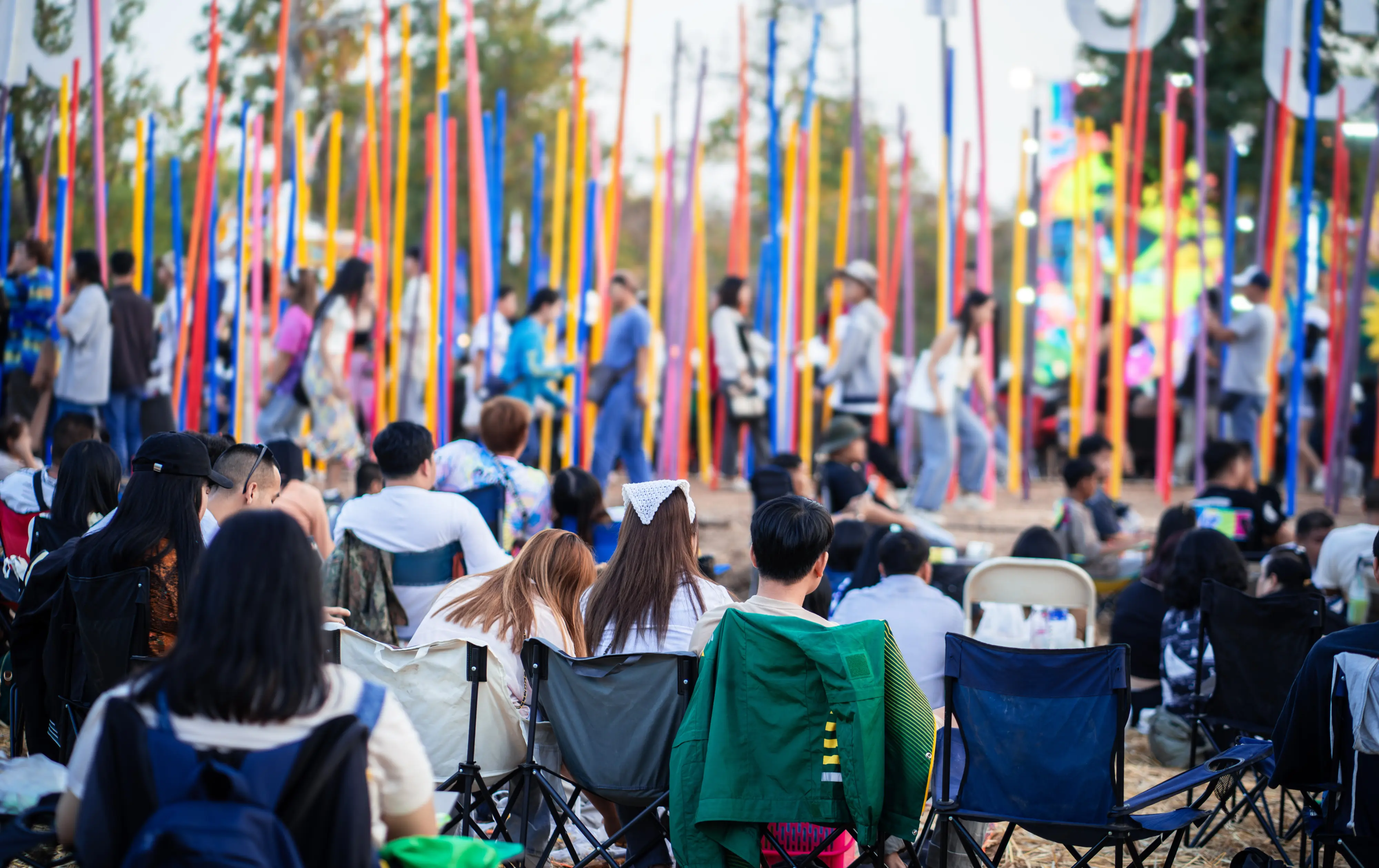 Outdoor community event with colorful poles