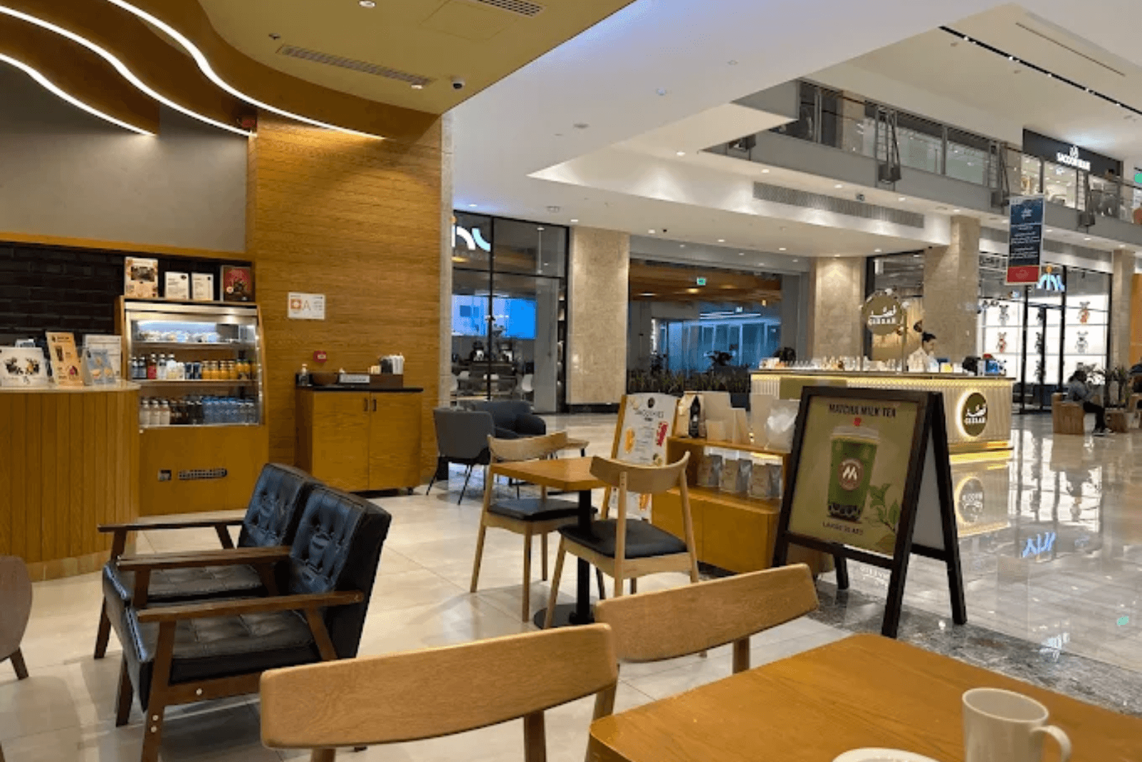 Cosy cafe in Abu Dhabi mall with warm-toned design at Milestones Coffee.