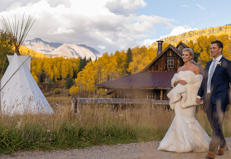 Wedding ceremony at Dunton Hot Springs with rustic cabins and mountain scenery.