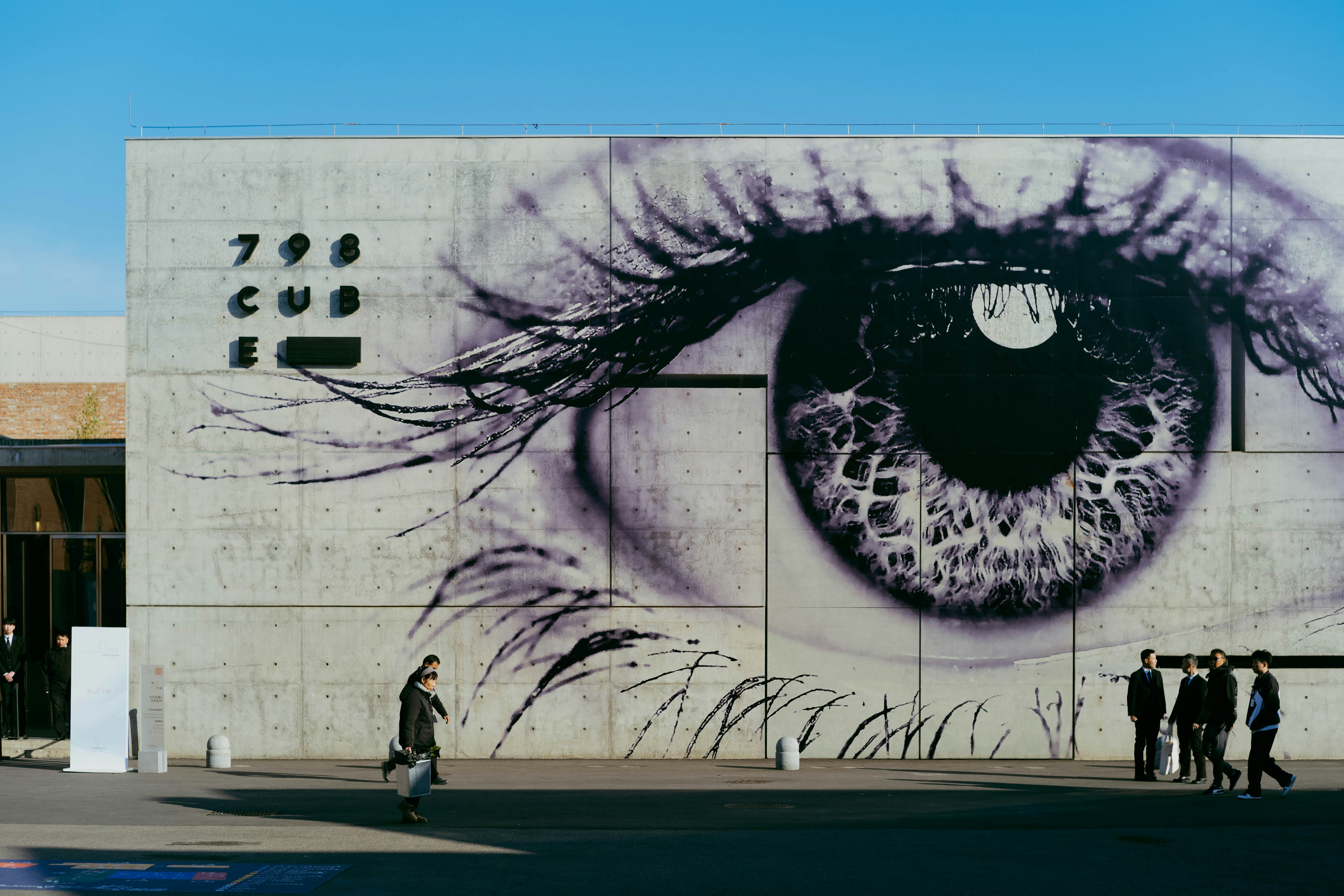 Giant eye mural on a concrete building facade