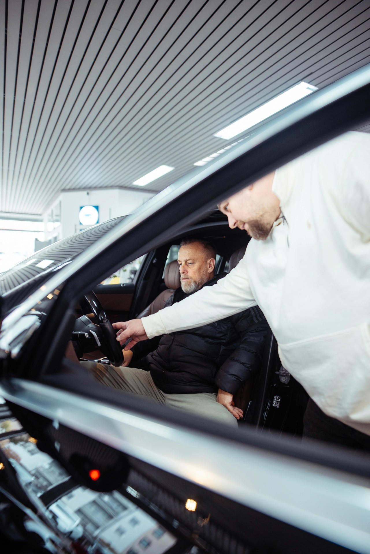 Luxury cars parked inside store.