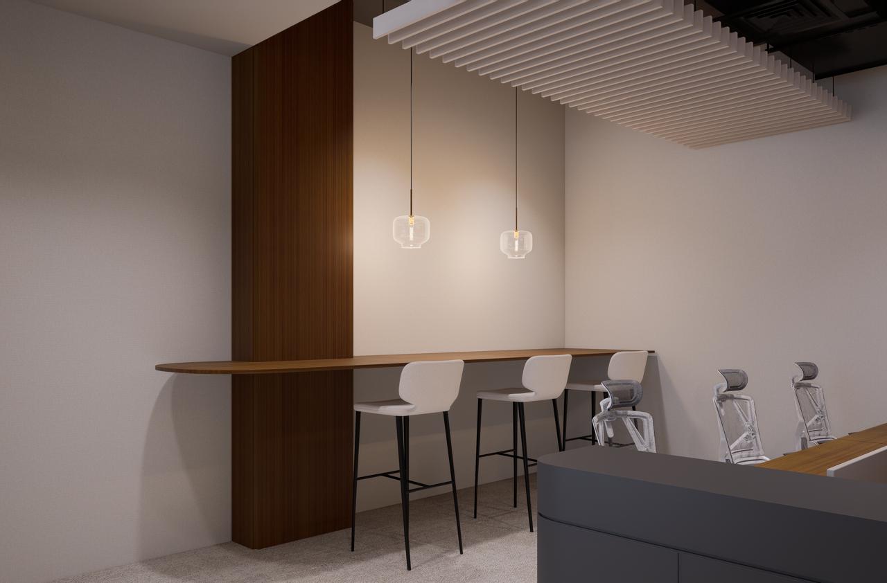 Quiet breakout space in serviced office spaces in Dubai with bar stools, pendant lighting, and acoustic ceiling panels.
