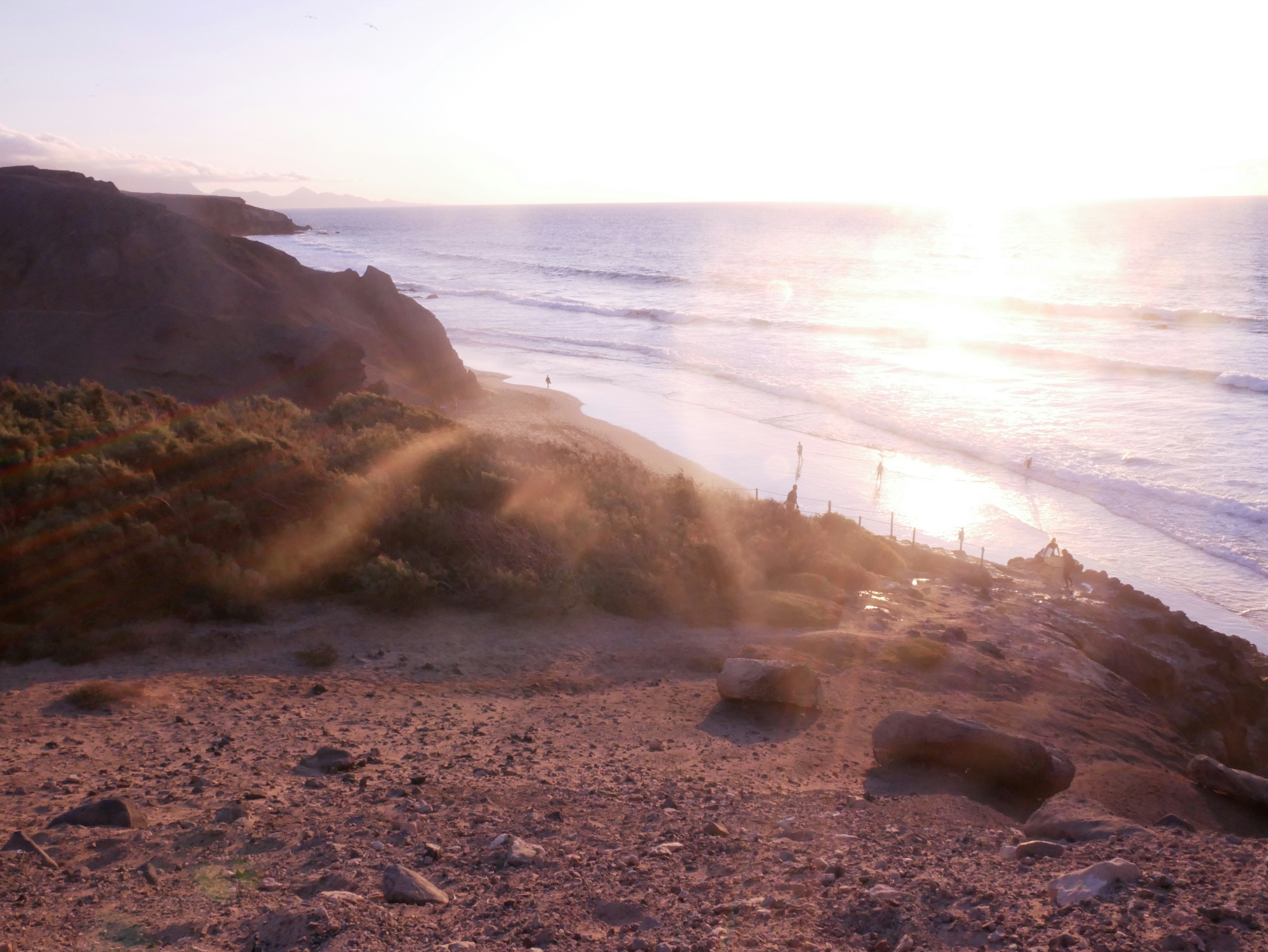 the sun is shining down on the beach