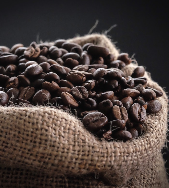 Roasted Ethiopia Guji beans spilling from a hessian sack