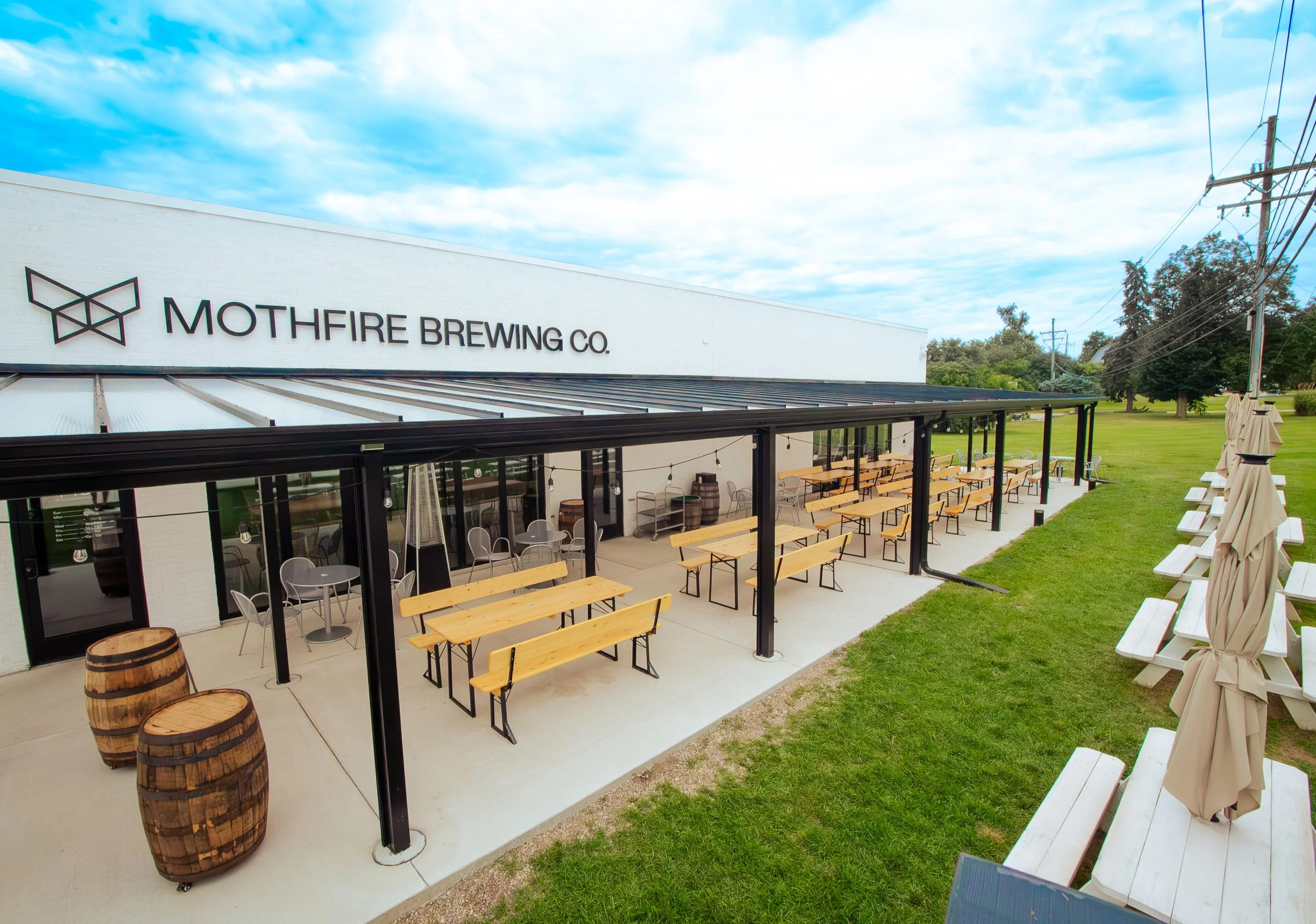 exterior of a building with white brick and a covered patio