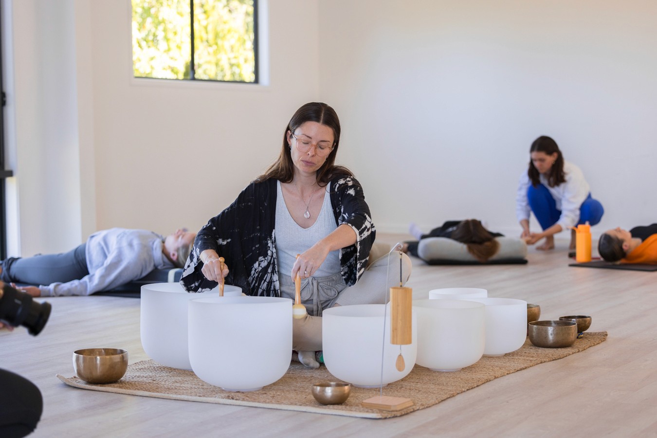 Woman playing sound bowls