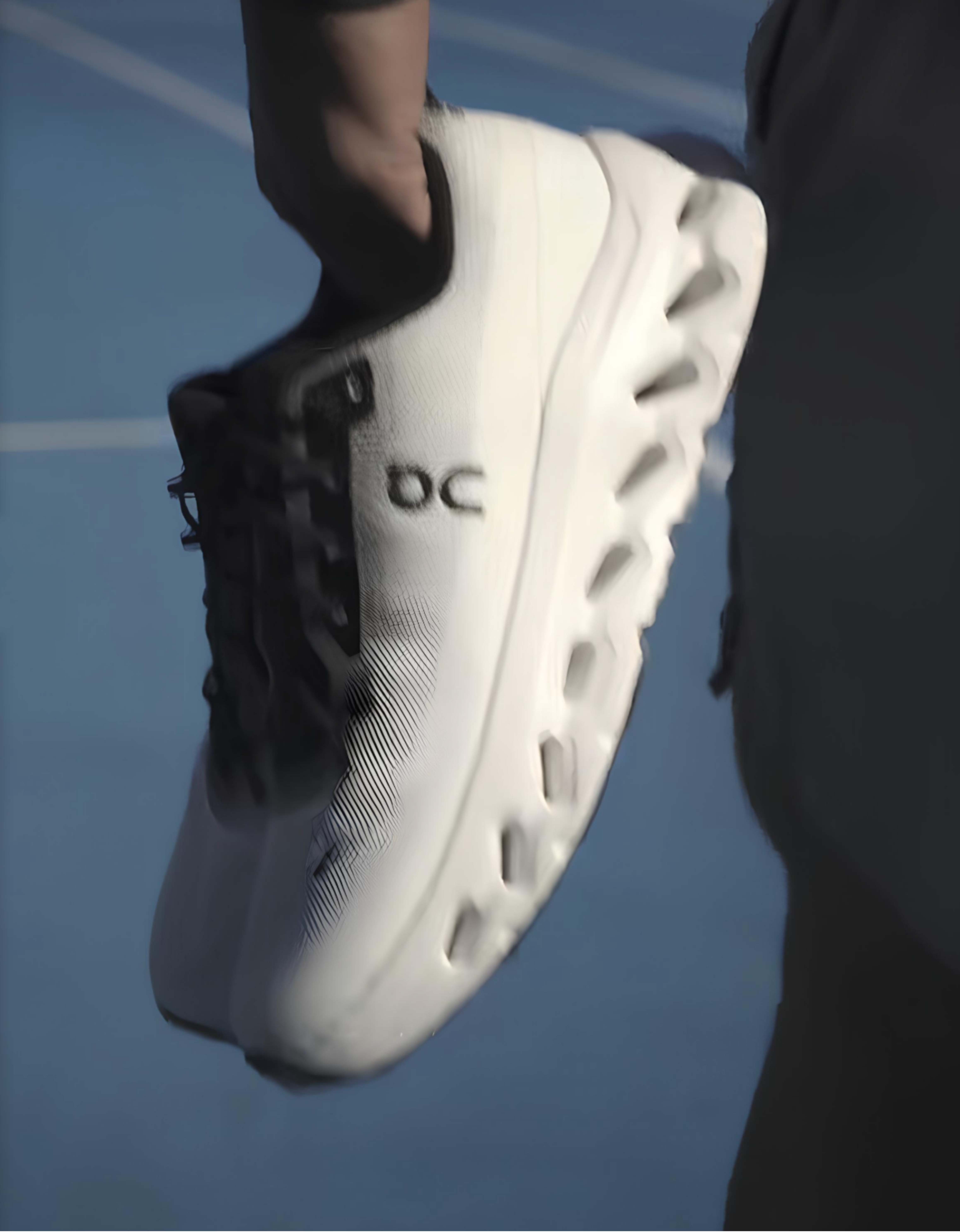 Product photography of an ON Running shoe worn during a Footlocker promotional shoot.