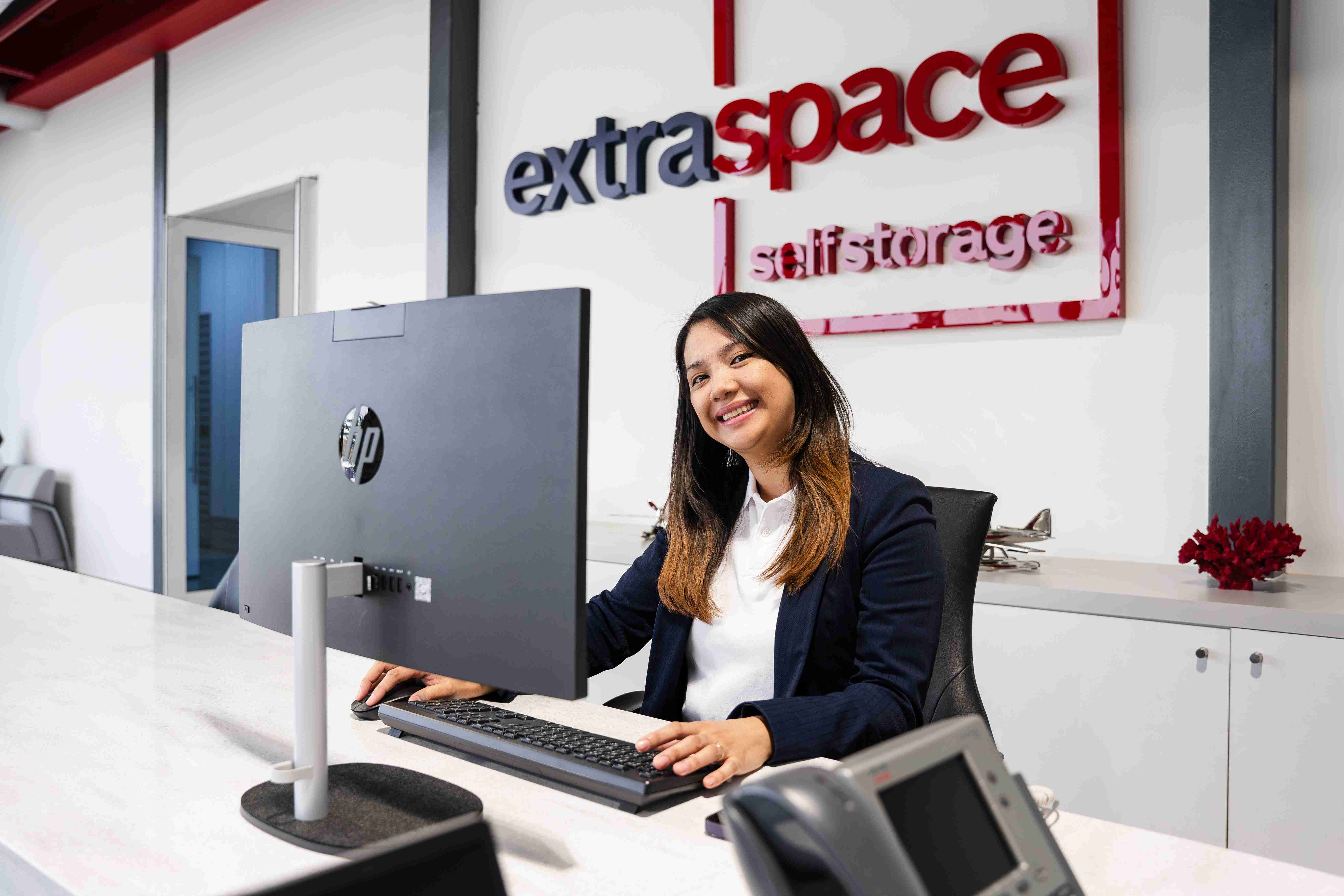 Reception area with a staff member at the front desk.