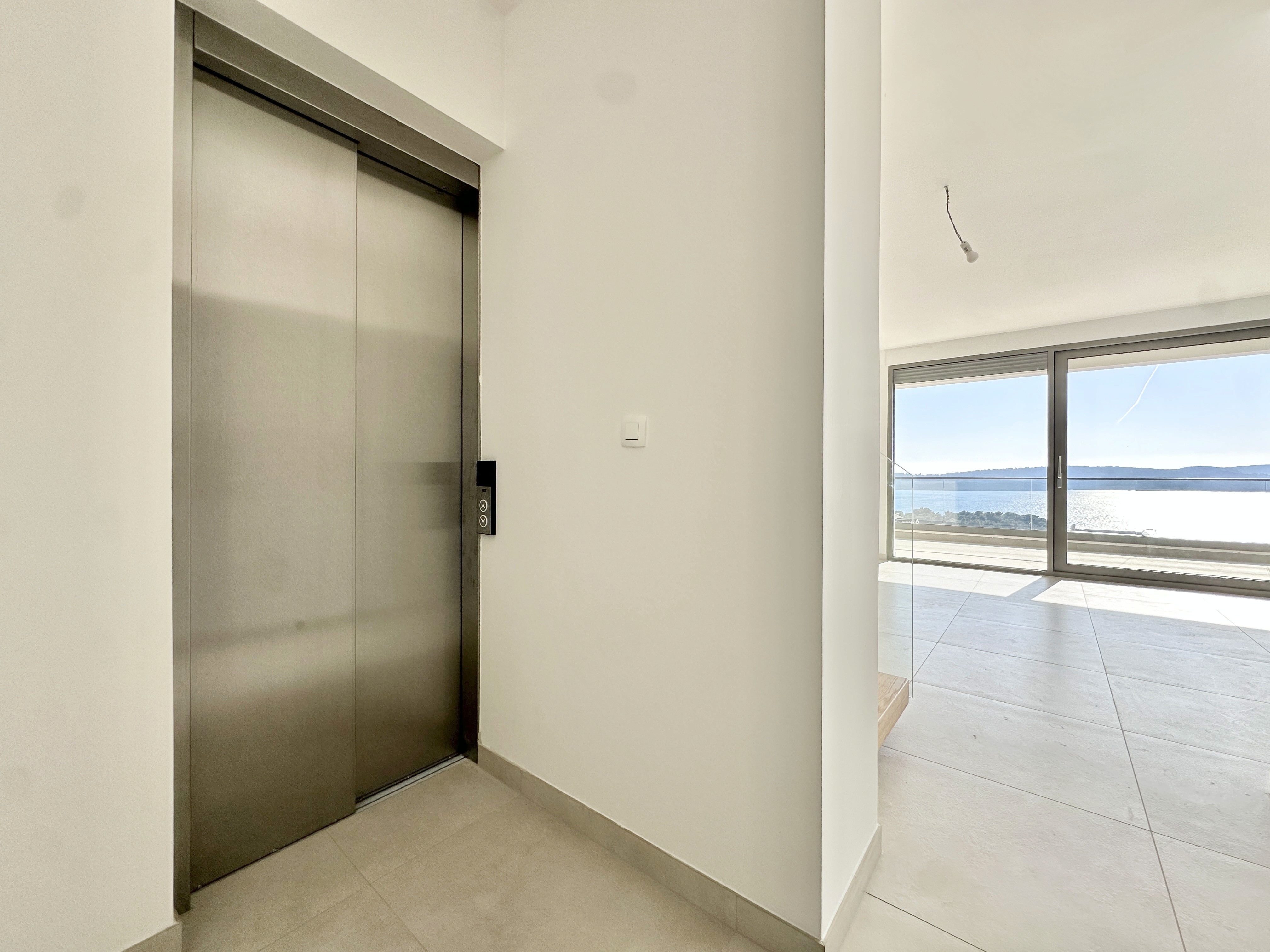 Ornate classic bathroom with claw-foot tub and wood paneling.