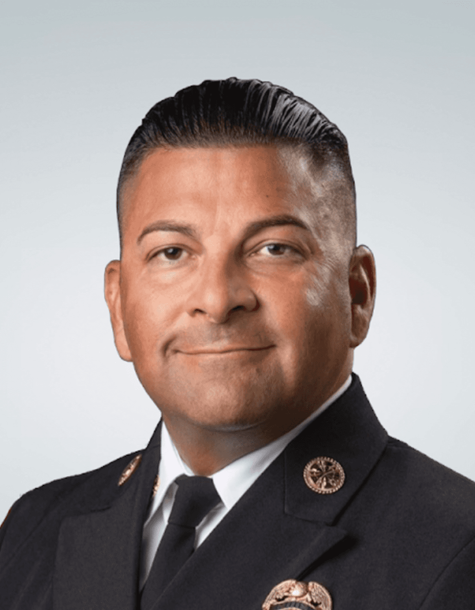 Silvio Lanzas, Chief Operating Officer of M-Fire Suppression, wearing fire department uniform