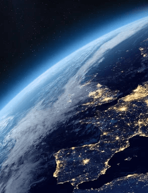 Satellite view of Earth at night showing Europe illuminated by city lights against a dark space background.