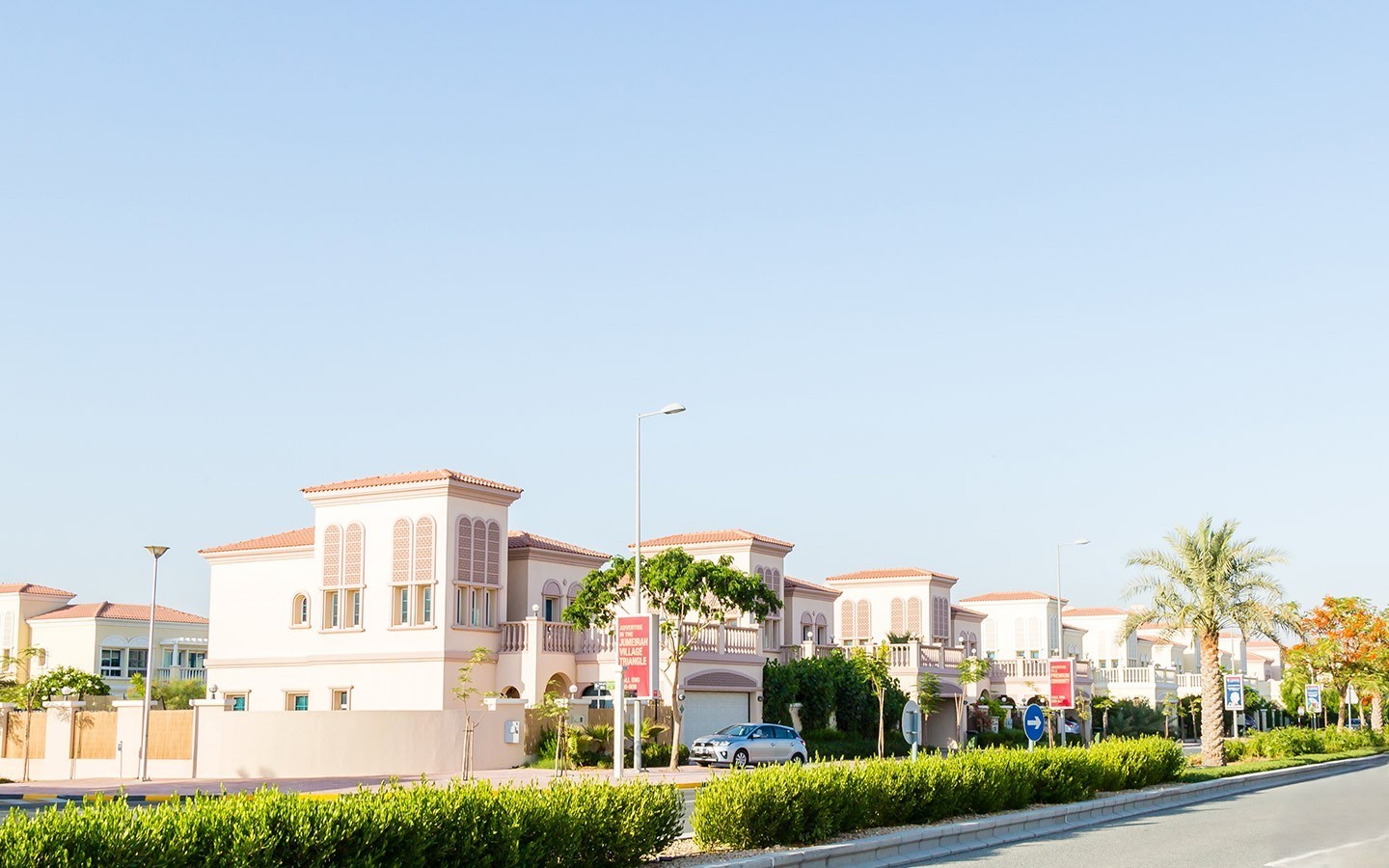 Exterior of the modern high-rise building Milano Giovanni Boutique Suites in Jumeirah Village Circle on a sunny day.