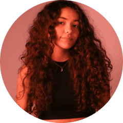 Sara is a client smiling to the camera happily