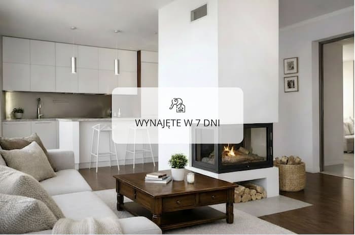 Salon z aneksem kuchennym i kominkiem w nowoczesnym mieszkaniu w Otwocku