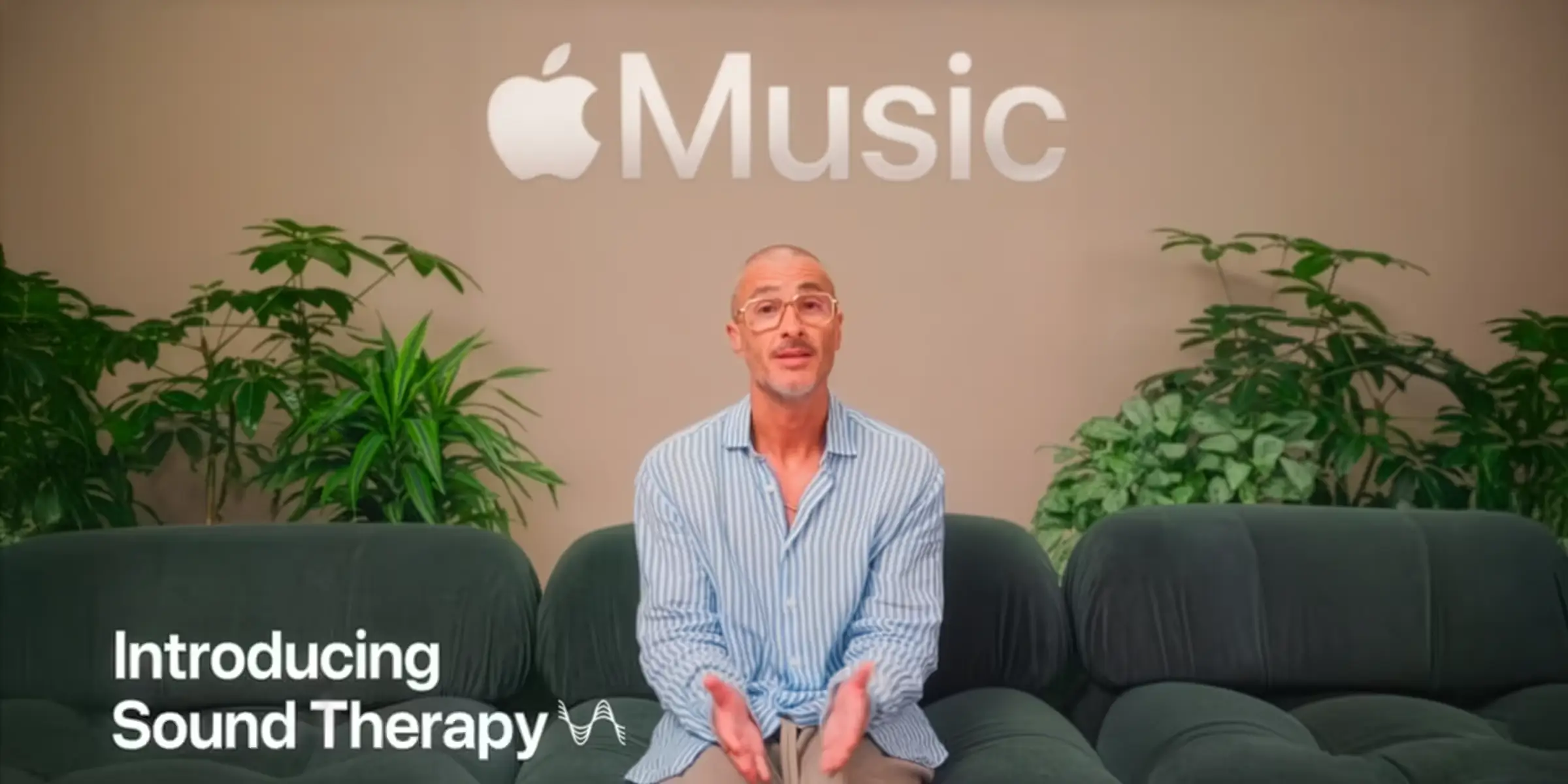 Apple Music studio shot with a presenter seated on a sofa and on-screen text reading “Introducing Sound Therapy.”