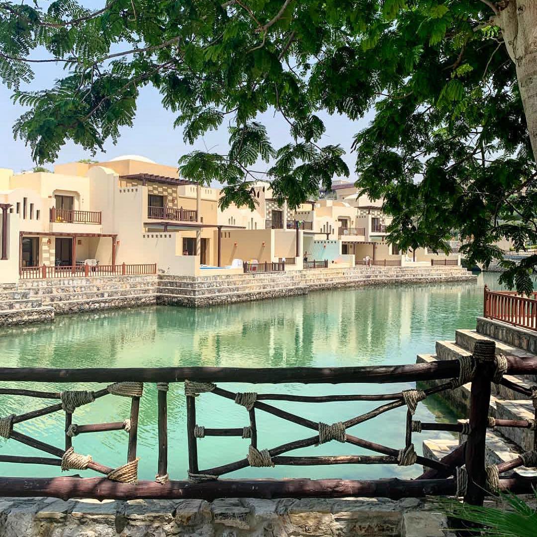 Scenic view of The Cove Rotana Resort showcasing luxurious villas and serene beachfront along the turquoise waters.