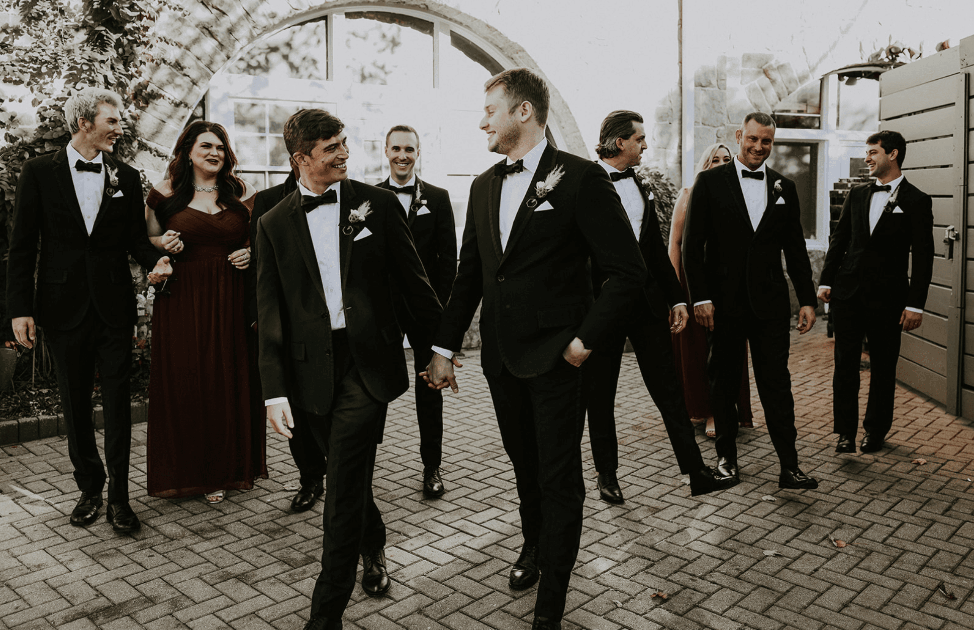 Wedding party walking together through the courtyard at Park Tavern Garden Tent in Atlanta.
