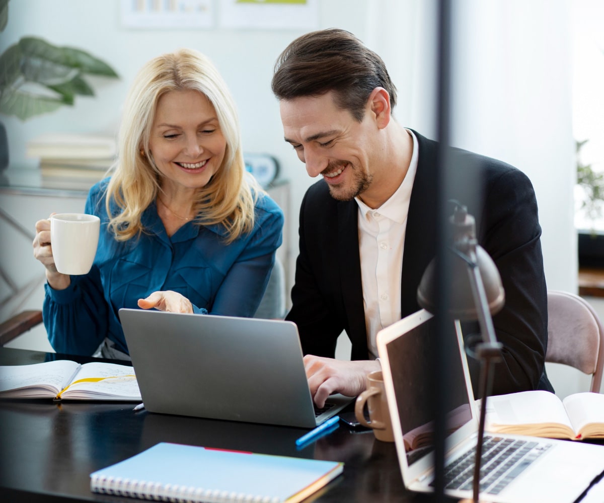 A close-up of a hand holding a small pine cone with a blurred natural background.