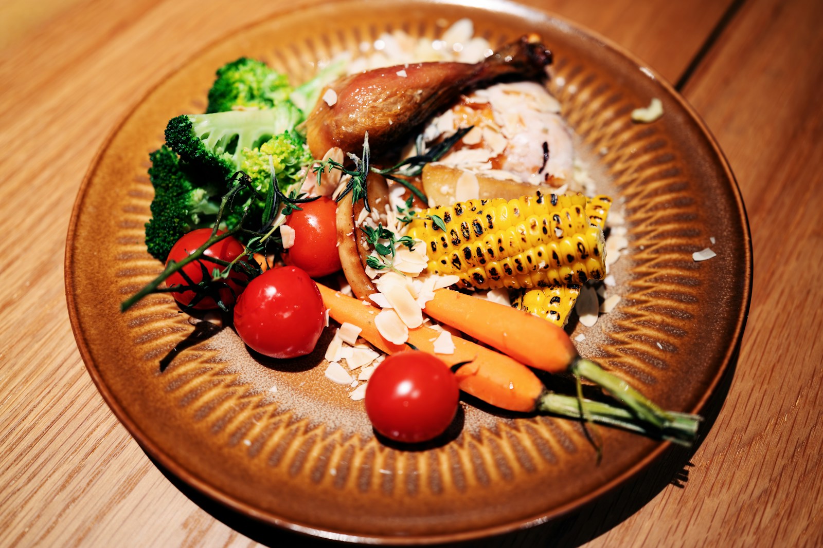 A balanced plate of roasted chicken, rice, and fresh vegetables showing carbohydrates, protein, and fats together