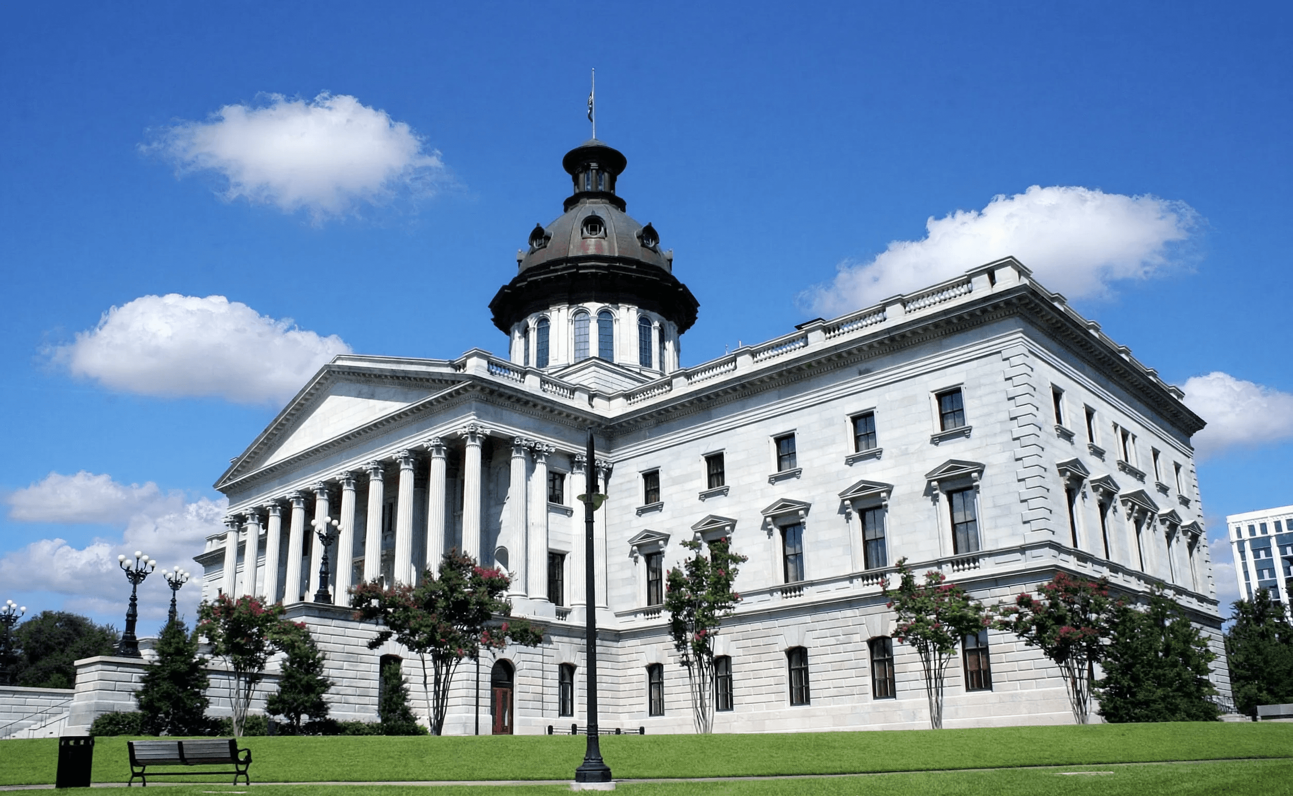Three children jumping in burlap sacks during a race.