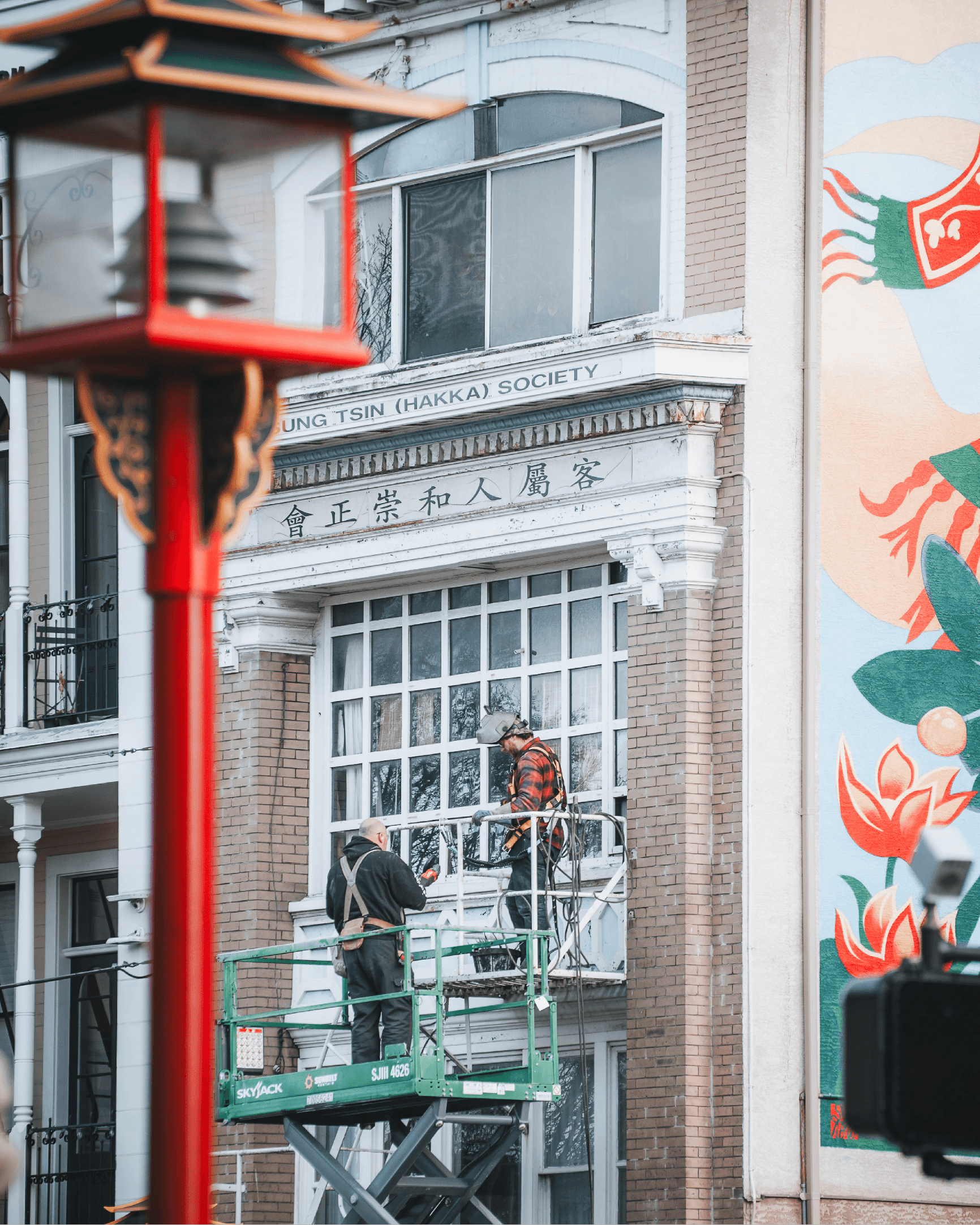 Vibrant street scene featuring a red pole and colourful painted building facade