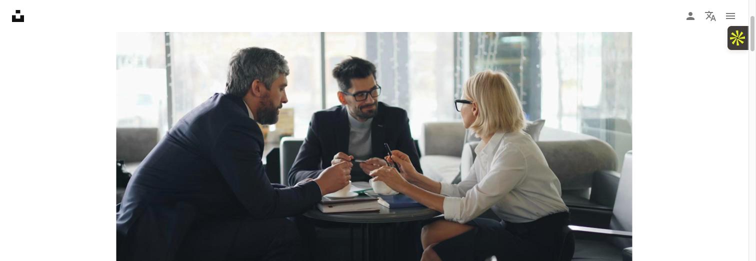 Professionals in a consultation meeting discussing a legal case at a modern office