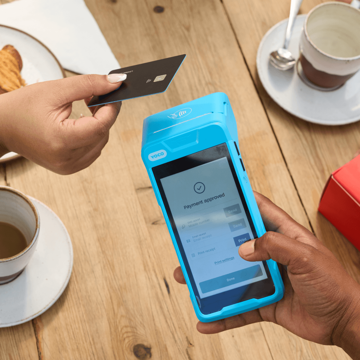 A customer paying with a card on a Yoco card machine
