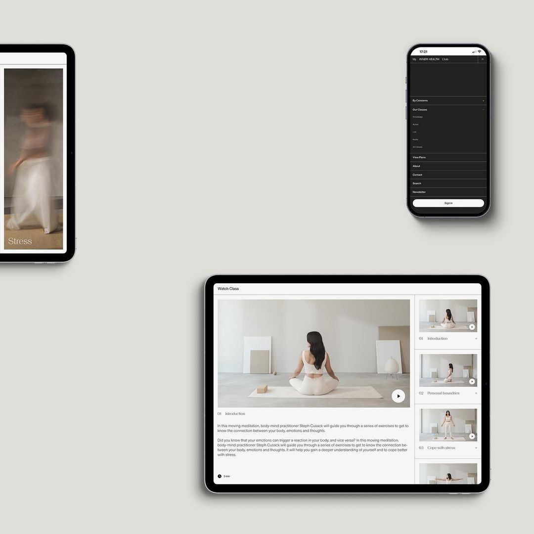 braided woman taking photo beside yellow painted wall