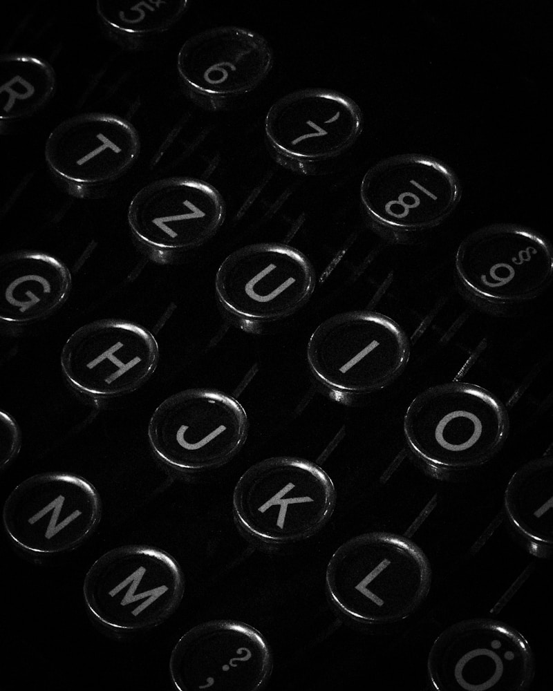 Close-up of typewriter keys arranged in precise rows, lit against near-black