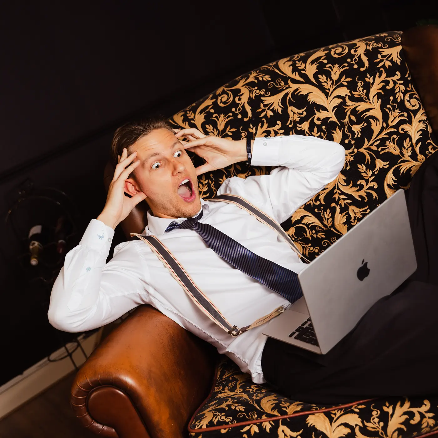 A red hot air balloon glows at sunset over mountains.