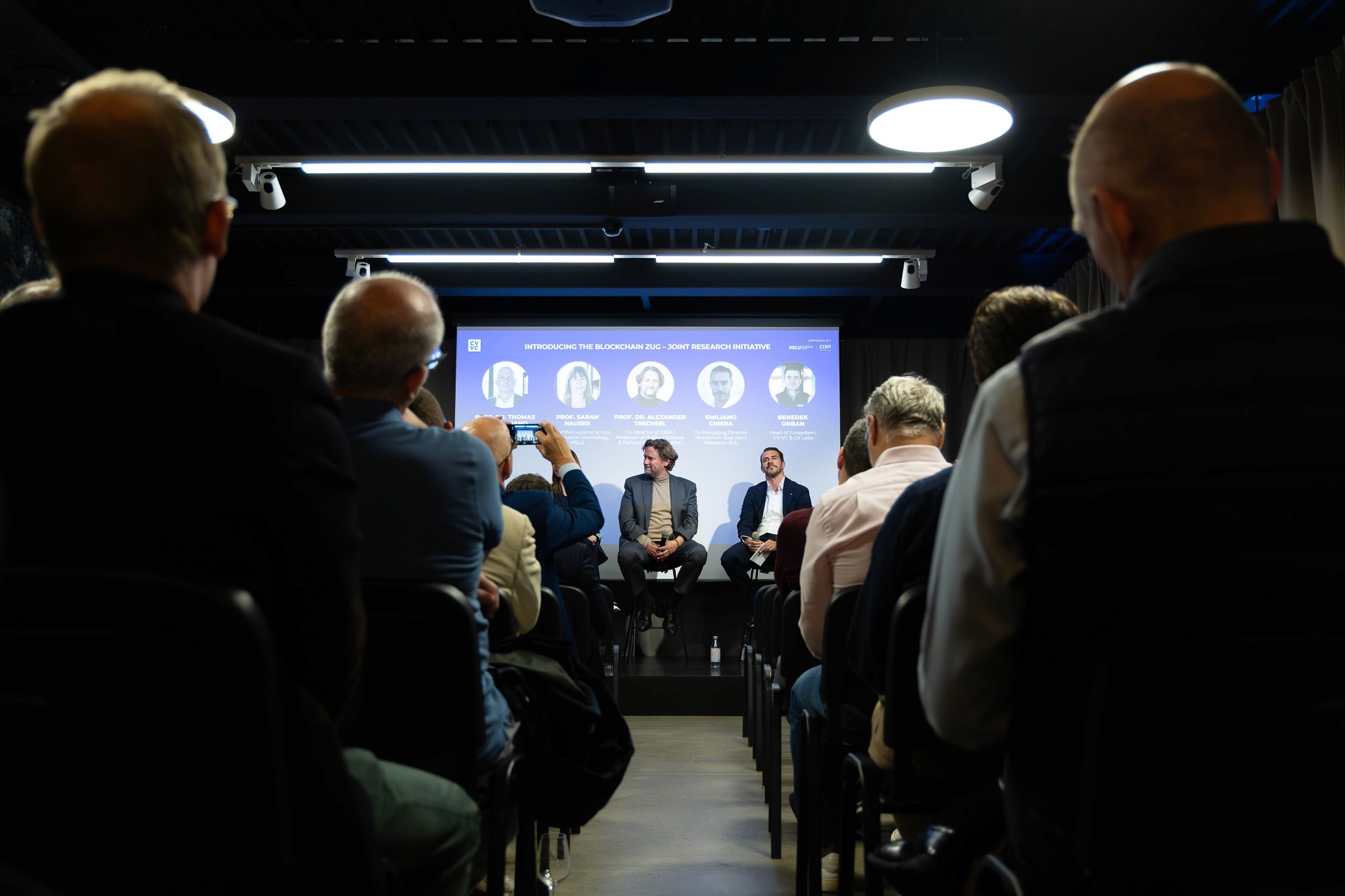 Audience attending a blockchain panel discussion in Zug.