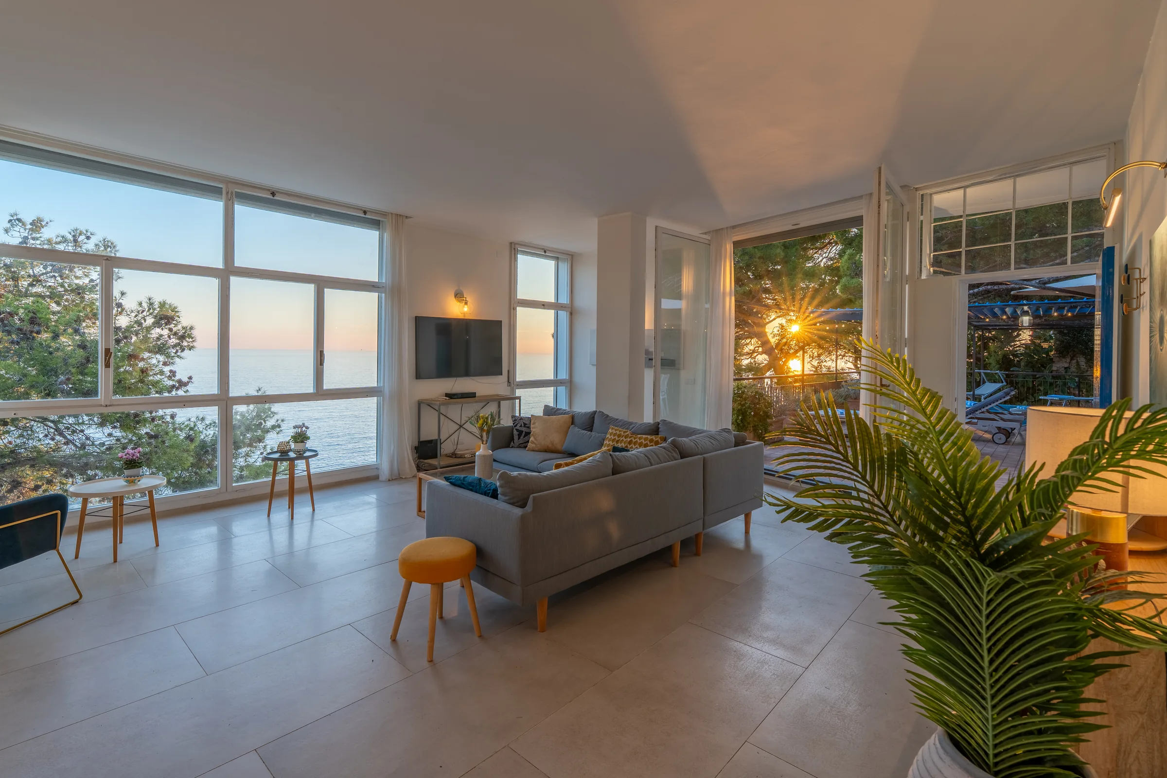 Coastal villa living room at twilight — Sori, Italian Riviera. Photography by Yunes Calore.