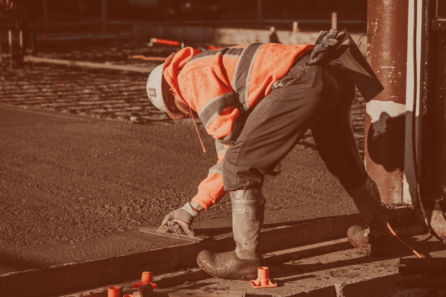 Construction Worker finishing concrete. He is able to focus because his systems are being handled.