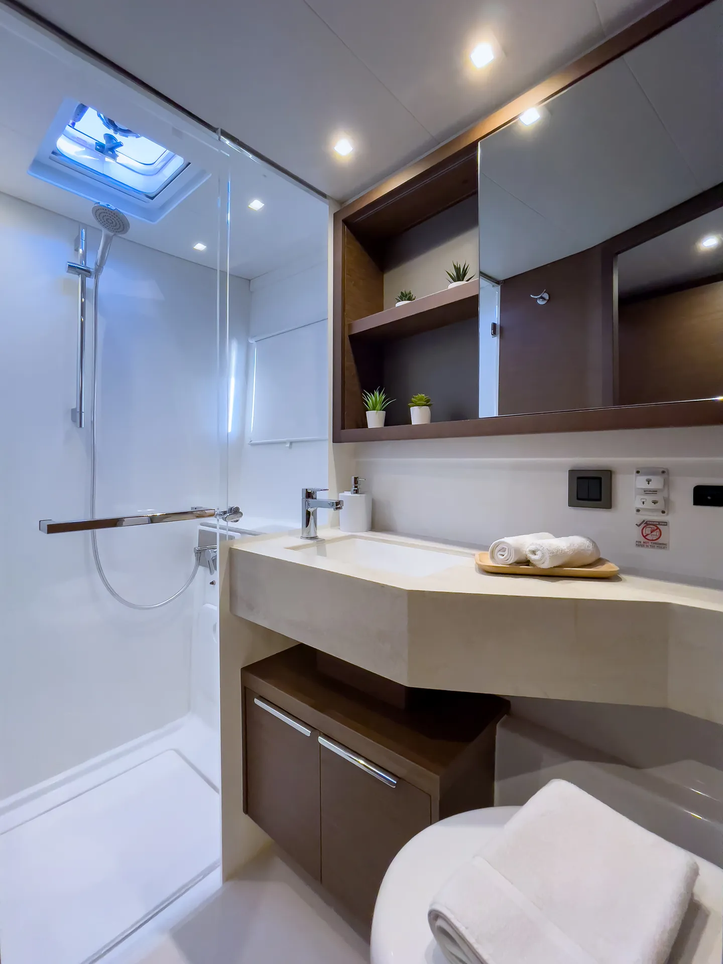 White Rock 36 speedboat with captain at helm cruising calm blue waters near Paros coastline with hills in background.