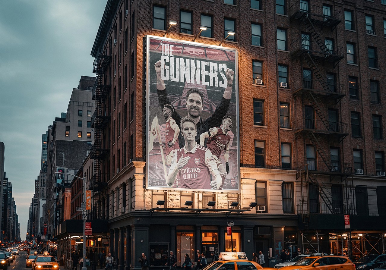Massive outdoor building billboard mockup displaying a custom sports branding and illustration poster for Arsenal FC titled The Gunners with bold athletic typography.